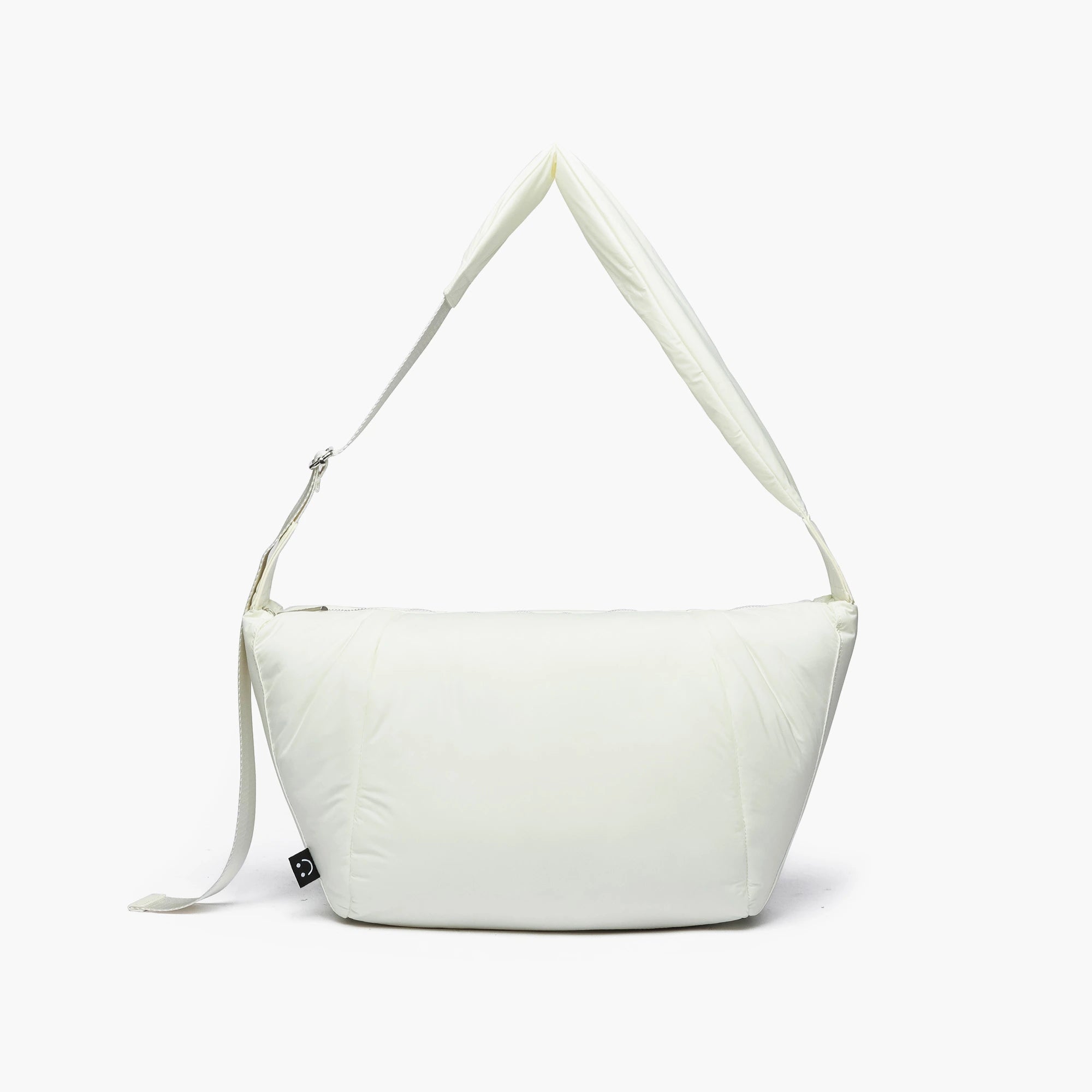 Ivory quilted puffer bag with a wide padded shoulder strap and a sleek minimalist design